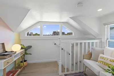 a living room with a staircase and a window at 5BD Home with outdoor space in Little Italy in San Diego