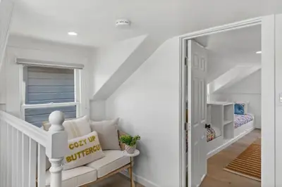 a white room with a couch and a mirror at 5BD Home with outdoor space in Little Italy in San Diego