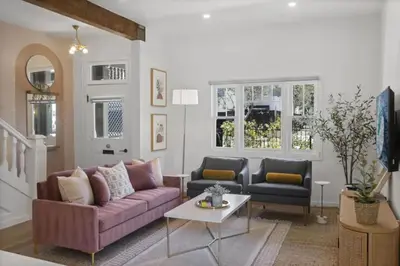 a living room with a purple couch and two chairs at 4BD Home in the Heart of Little Italy in San Diego