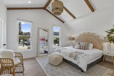 a bedroom with a large bed and a chair at 4BD Home in the Heart of Little Italy in San Diego