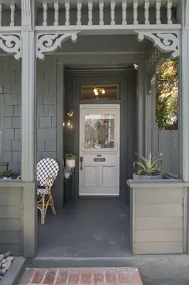 a porch with a white door and a chair at 4BD Home in the Heart of Little Italy in San Diego