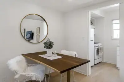 a dining room with a table and a mirror at Cozy 1 BR Casita Overflowing with Natural Light in San Diego