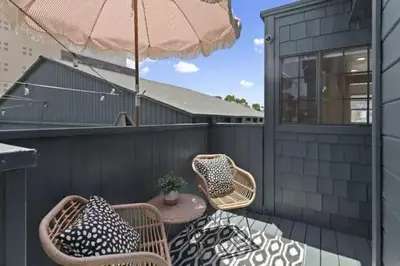 a patio with chairs and a table and an umbrella at Cozy 1 BR Casita Overflowing with Natural Light in San Diego