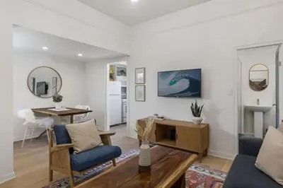 a living room with a couch and a table at Cozy 1 BR Casita Overflowing with Natural Light in San Diego