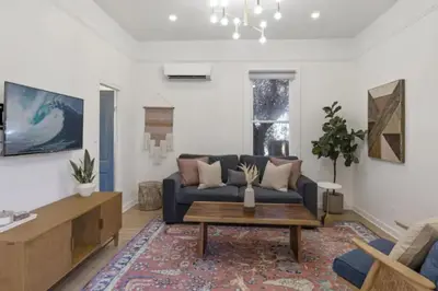 a living room with a blue couch and a coffee table at Cozy 1 BR Casita Overflowing with Natural Light in San Diego