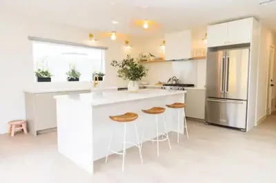 a kitchen with white counters and a refrigerator at Bright, Spacious 4 BD in the Heart of Little Italy in San Diego