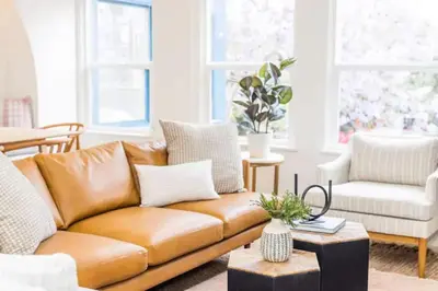 a living room with a brown leather couch at Bright, Spacious 4 BD in the Heart of Little Italy in San Diego