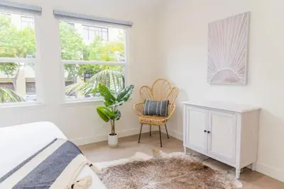 a bedroom with a bed and a desk and a chair at Cheerful 4BD Home in the Heart in San Diego