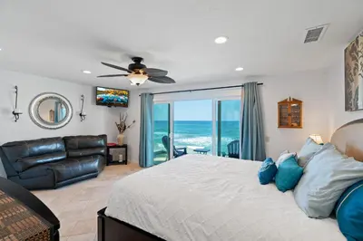a bedroom with a bed and a view of the ocean at Sunsets at the Beach House in Oceanside