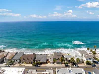 an aerial view of a beach with houses and the ocean at Sunsets at the Beach House in Oceanside