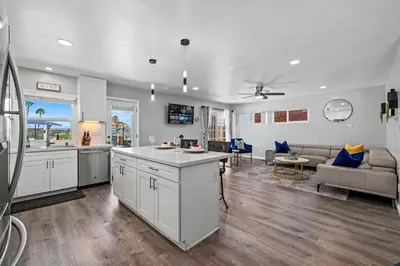 a large kitchen and living room with a couch at The Sky Lounge in La Mesa