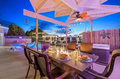 a table with chairs and an umbrella on a patio at The Sky Lounge in La Mesa