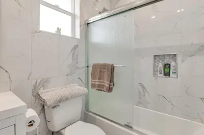 a bathroom with a shower and a toilet and a sink at 2 Mi to Downtown Escondido Apt with Balconies in Escondido