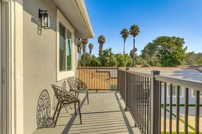 a balcony with two chairs and a table at 2 Mi to Downtown Escondido Apt with Balconies in Escondido
