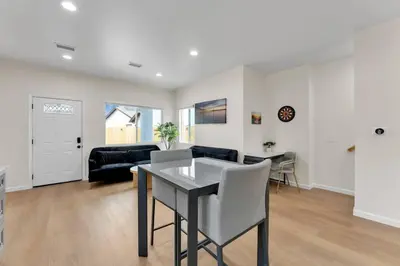 a living room with a table and a couch at Urban Retreat Fun Relax Self Check-In Hot Tub Foosball Fire Pit Cornhole in The Woods Trailer Park