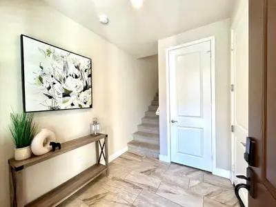 a hallway with a staircase with a painting of flowers at Irvine Luxury 2Bedroom 2Bathroom Portola Springs in East Irvine