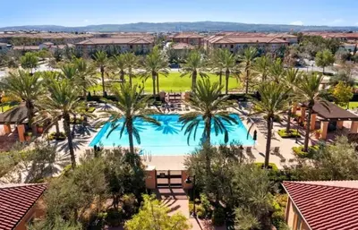 an aerial view of a resort pool with palm trees at Irvine Luxury 2Bedroom 2Bathroom Portola Springs in East Irvine