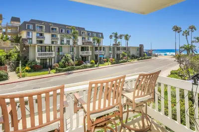 two benches on a balcony with a view of a street at C4 - Coastal Cottage in Oceanside
