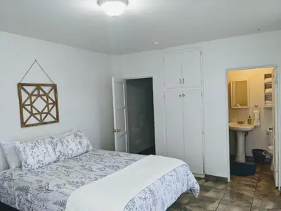 a white bedroom with a bed and a sink at Centrally Located 2 Master Bedrooms to Explore all San Diego has to Offer in San Diego
