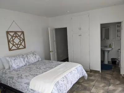 a white bedroom with a bed and a sink at Centrally Located 2 Master Bedrooms to Explore all San Diego has to Offer in San Diego