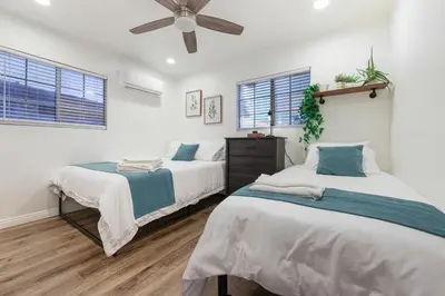 a bedroom with two beds and a ceiling fan at Spacious Family Retreat in the heart of San Diego in San Diego