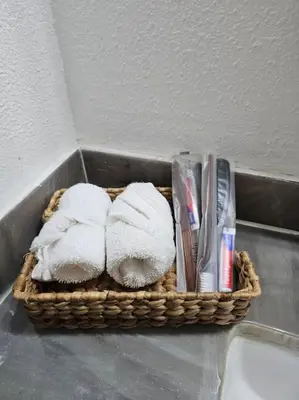 a basket of towels and toothbrushes in a bathroom at Spacious Family Retreat in the heart of San Diego in San Diego
