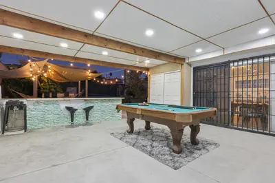 a pool table in a patio with a bar at Spacious Family Retreat in the heart of San Diego in San Diego