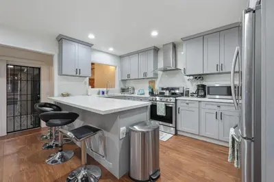 a kitchen with white cabinets and stainless steel appliances at Spacious Family Retreat in the heart of San Diego in San Diego