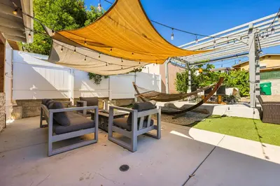 a hammock and chairs on a patio with a hammock at Spacious Family Retreat in the heart of San Diego in San Diego