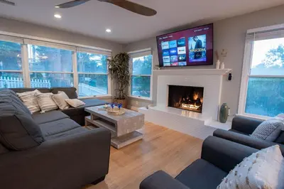 a living room with a couch and a fireplace at NEW! Pt Loma Paradise: Remodel - Pool – Game Room – WOW! in San Diego