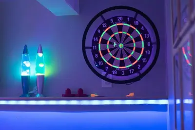 a dart board on a shelf with two candles at NEW! Pt Loma Paradise: Remodel - Pool – Game Room – WOW! in San Diego