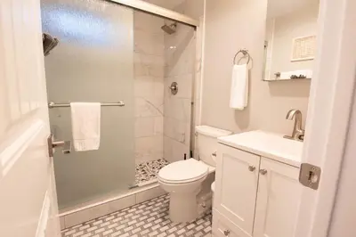 a bathroom with a shower and a toilet and a sink at NEW! Pt Loma Paradise: Remodel - Pool – Game Room – WOW! in San Diego