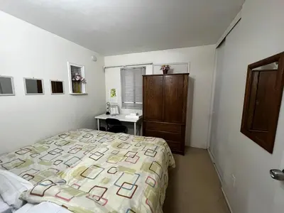 a bedroom with a bed and a desk in it at A Bridge to All San Diego Central Pool Home Private Room in San Diego