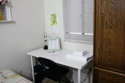 a white desk with a chair next to a window at A Bridge to All San Diego Central Pool Home Private Room in San Diego