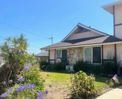 a house with flowers in the front yard at A Bridge to All San Diego Central Pool Home Private Room in San Diego