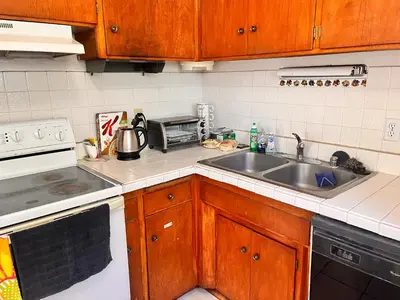 a kitchen with a sink and a stove at A Bridge to All San Diego Central Pool Home Private Room in San Diego