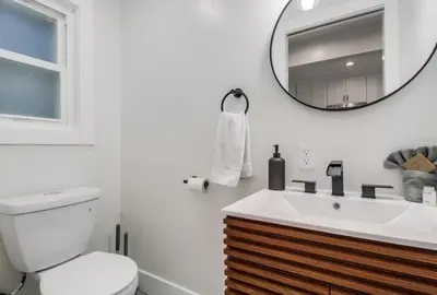 a bathroom with a toilet and a sink and a mirror at Spectacular Seaview Oasis -Views Spa Game Room in San Diego