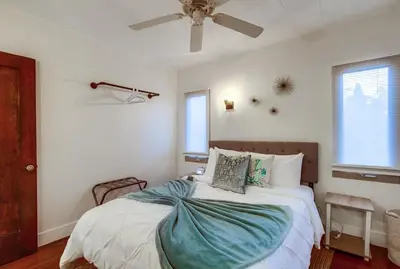 a bedroom with a bed with a ceiling fan at Spectacular Seaview Oasis -Views Spa Game Room in San Diego