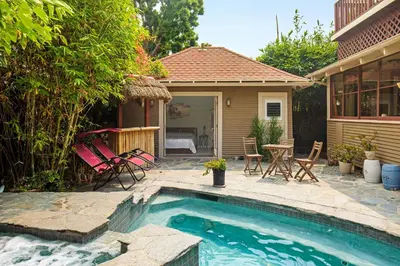 a pool with chairs and a table and a house at Pool Room - Entire Guest Suite - Private Entrance in San Diego