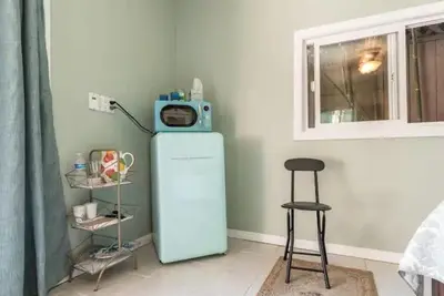 a room with a refrigerator with a microwave on top of it at Pool Room - Entire Guest Suite - Private Entrance in San Diego
