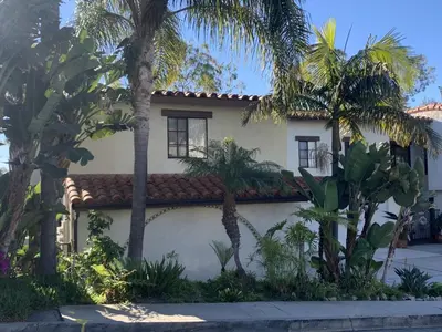 a house with palm trees in front of it at San Clemente Beach home walk to beach and downtown in San Clemente