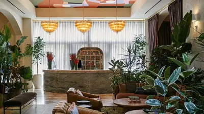 a lobby with potted plants and a bar at Granger Hotel San Diego Downtown Gaslamp Quarter, a Member of Design Hotels in San Diego