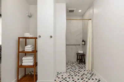 a bathroom with a shower with a glass door at Granger Hotel San Diego Downtown Gaslamp Quarter, a Member of Design Hotels in San Diego