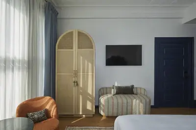 a living room with a door and a chair and a room at Granger Hotel San Diego Downtown Gaslamp Quarter, a Member of Design Hotels in San Diego