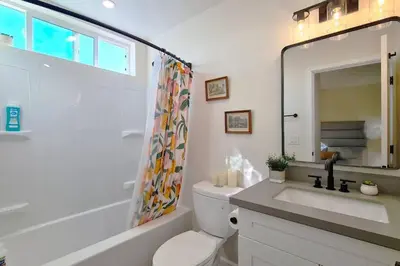 a bathroom with a toilet and a sink and a mirror at Entire Private Home with 3 Bedrooms 3 Bathrooms, Balcony Views, 10-mins to San Diego Gaslamp, Downtown, Available Now in National City