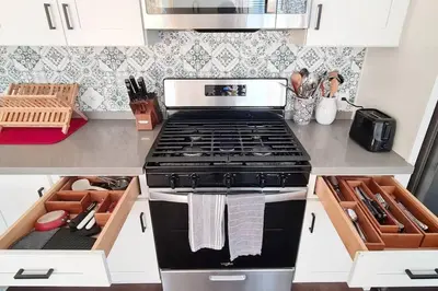 a kitchen with a stove top oven in a kitchen at Entire Private Home with 3 Bedrooms 3 Bathrooms, Balcony Views, 10-mins to San Diego Gaslamp, Downtown, Available Now in National City