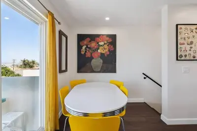 a room with a yellow stool and a table and a window at Entire Private Home with 3 Bedrooms 3 Bathrooms, Balcony Views, 10-mins to San Diego Gaslamp, Downtown, Available Now in National City