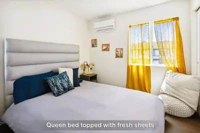 a bedroom with a white bed and a window at Entire Private Home with 3 Bedrooms 3 Bathrooms, Balcony Views, 10-mins to San Diego Gaslamp, Downtown, Available Now in National City