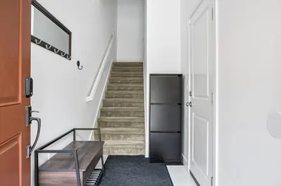a hallway with a staircase with a wooden table at Better Two-Gether 2-bed 2,5-bath in Oceanside