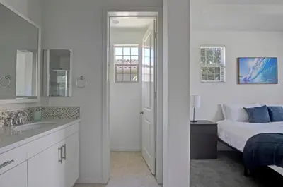 a white bathroom with a bed and a sink at Fun In The Sun 2 Bed 2 Bath Home in Oceanside